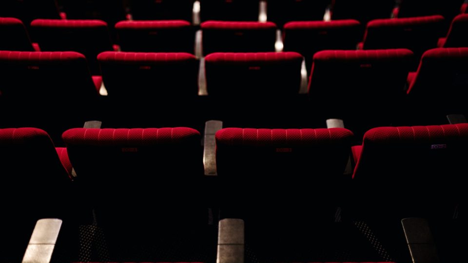 Rows of red seats in a theatre